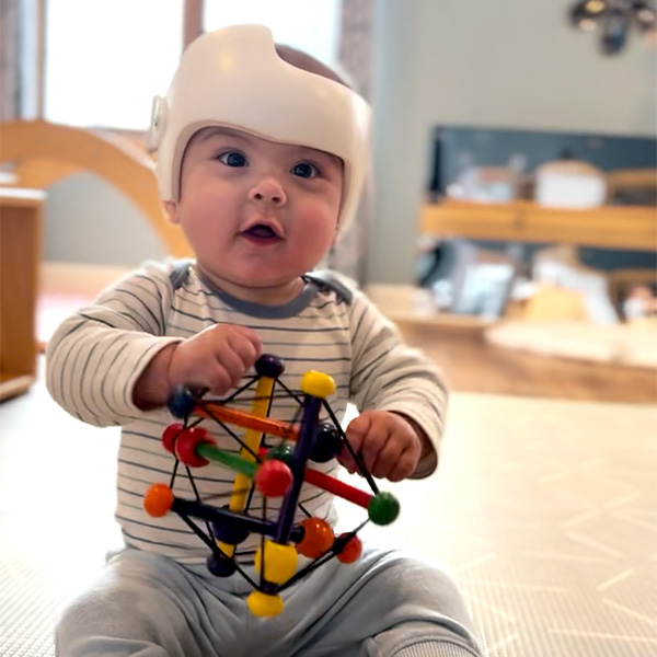 an infant playing with a toy