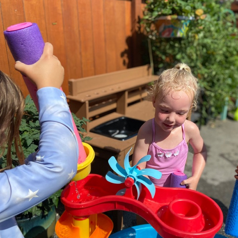 45c0a386 af02 4461 95ac 65bc51d93c72 1 105 c 1 a young girl playing with water toys in the sun