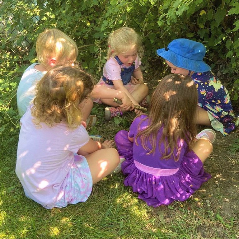 bfbe10e0 0be8 4750 91a3 b36a5c30d0fb 1 105 c 1 a group of children sitting in the grass